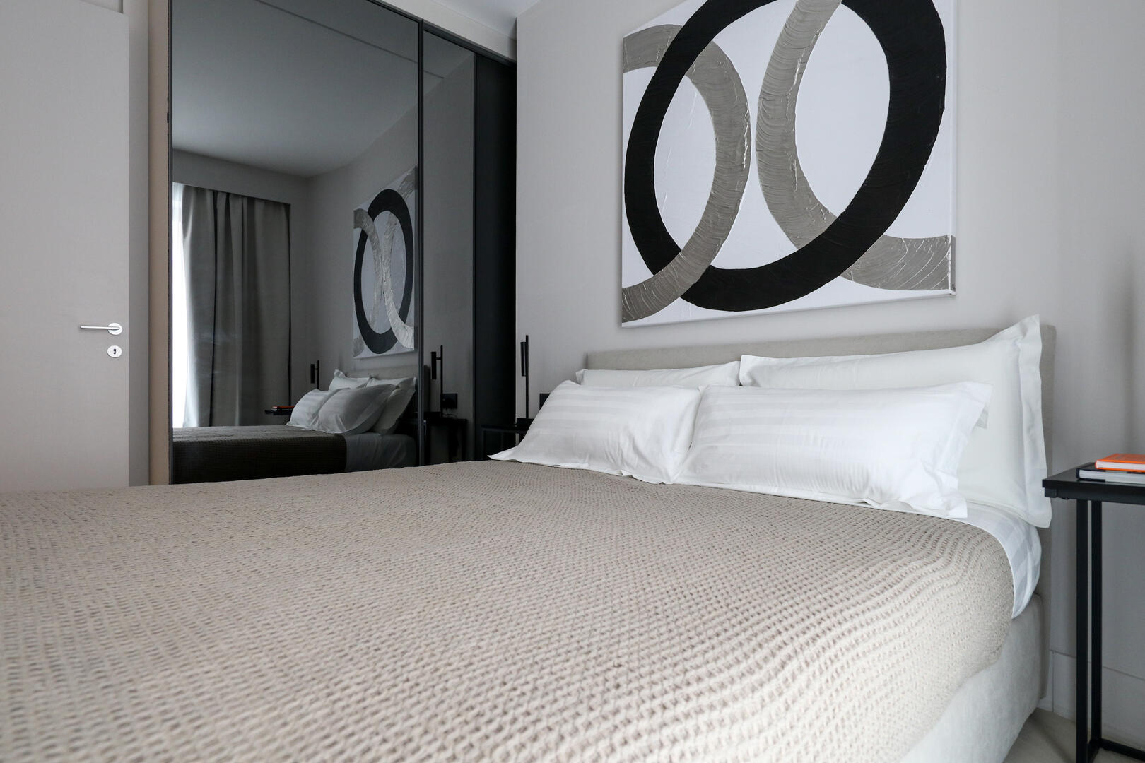 Comfortable king-size bed with premium linen and custom-made pillows for a great night's rest